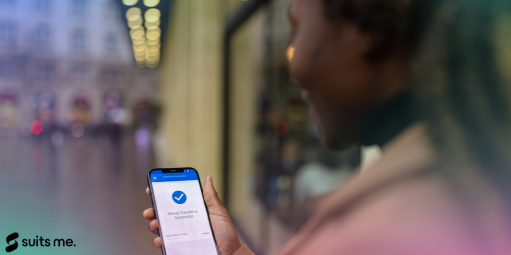 A woman holding a phone with money sent notification 