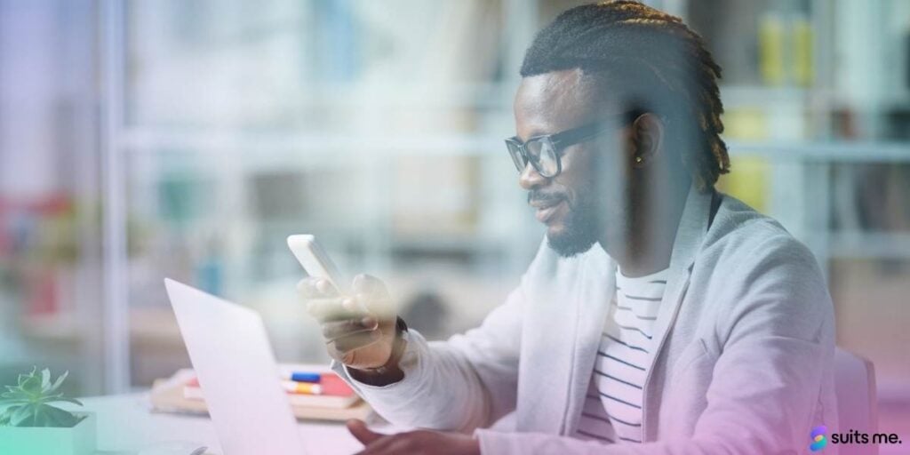 Young man in cafe using his mobile phone to check his checking account balance