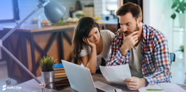 A man and women stressing about paying there bills making it harder as they do not have a bank account