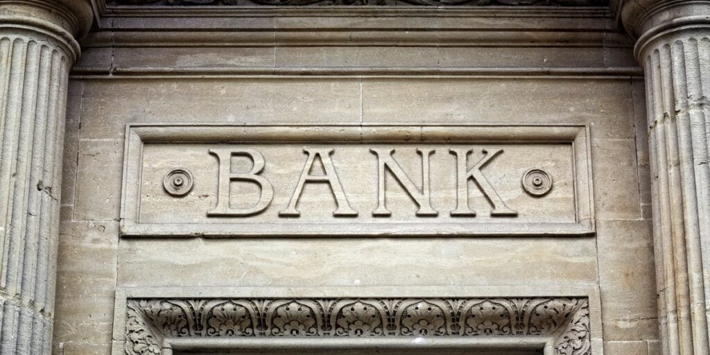 Old banking institute in old building. The word bank written on a brick wall