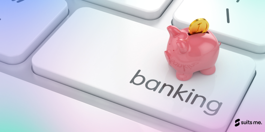 A piggy bank stood on a keyboard over they key saying banking