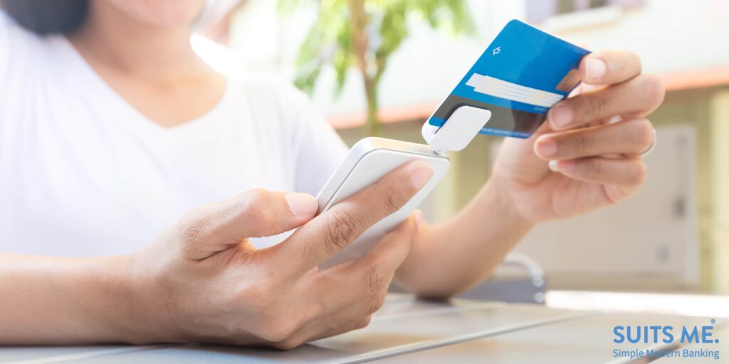 woman using card reader to add new payee to her mobile banking app