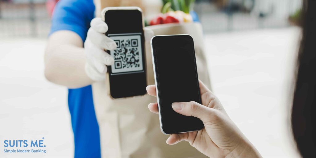 Female customer using digital payment method to safely pay for fresh goods during the coronavirus