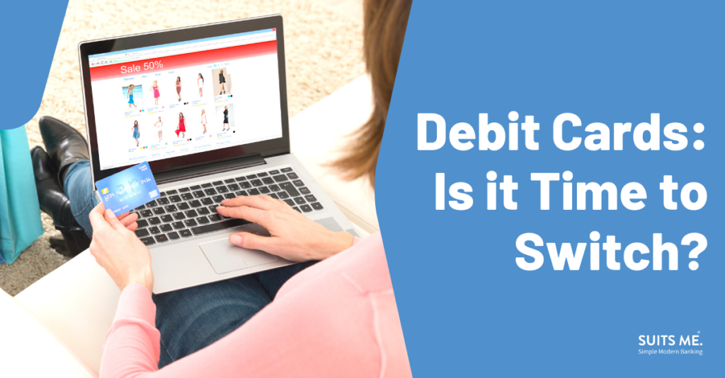 Debit Cards: Is it Time to Switch? in bold with a woman searching on a laptop with a debit card in hand