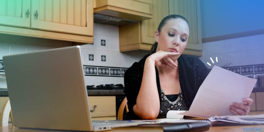 Woman sat at her dining table trying to figure out the best way to deal with her outstanding debts