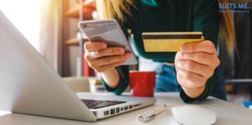 Woman's hands using laptop and holding credit card and smart phone with as digital banking concept