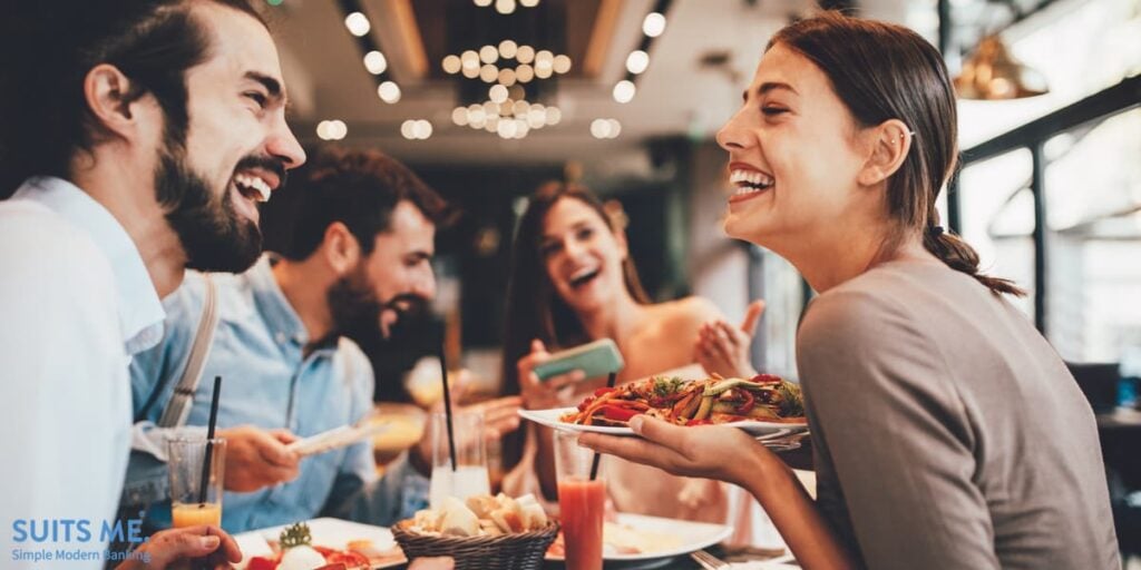 Group of friends enjoying food at a restaurant and making the most of the Government's Eat Out to Help Out Scheme