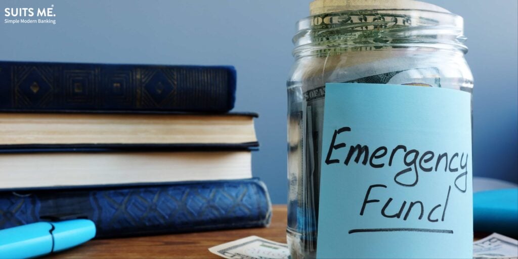 Emergency fund written on a jar with lots of money inside - creating an emergency fund concept