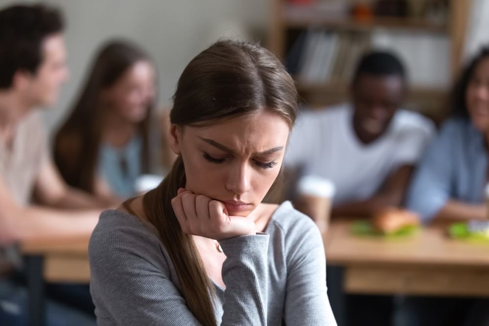 women looking upset as she is finically excluded