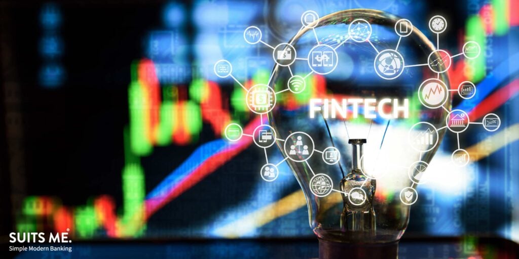 Fintech Investment Financial Internet Technology Concept. Light bulb on tablet and Stock graph and business technology icon with abstract electronic circuit background