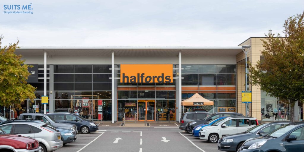 The exterior of a Halfords store with the car park