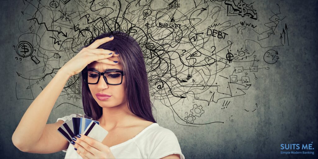 Concerned woman looking at many bank cards feeling anxious and scared about choosing an IVA