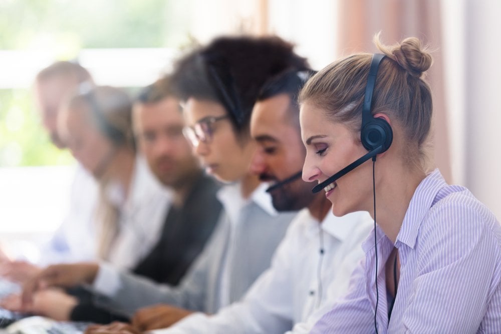 Customer service agents happily working in a call centre environment