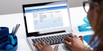 Woman on laptop using Online Banking to check her Bank Statements