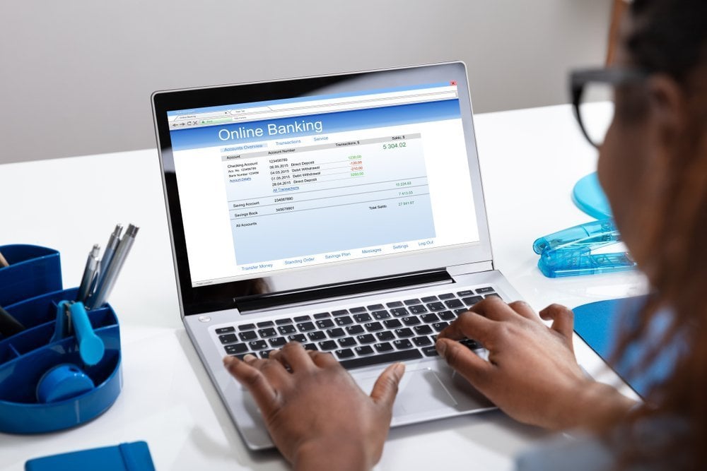 Woman on laptop using Online Banking to check her Bank Statements