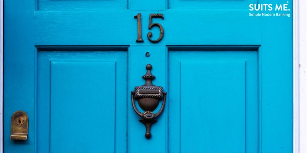 Closeup of House number 15 on a blue wooden front door. Representing Proof of Address