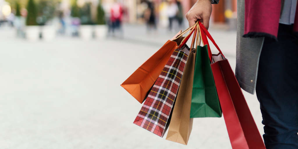 person holding shopping bags and spending money on the high street