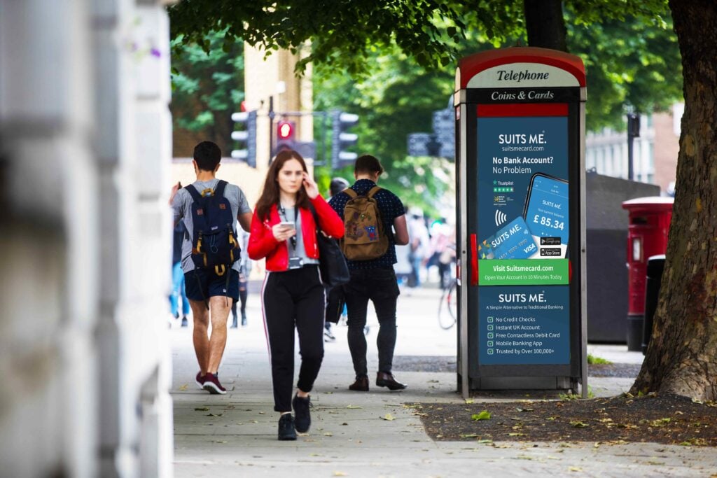 Streets of Manchester with Phone box featuring Suits Me® branding and logo