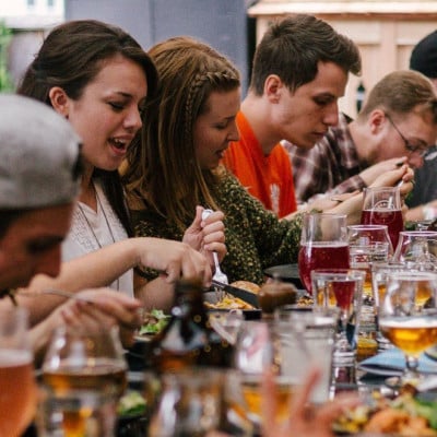 People eating food around a table