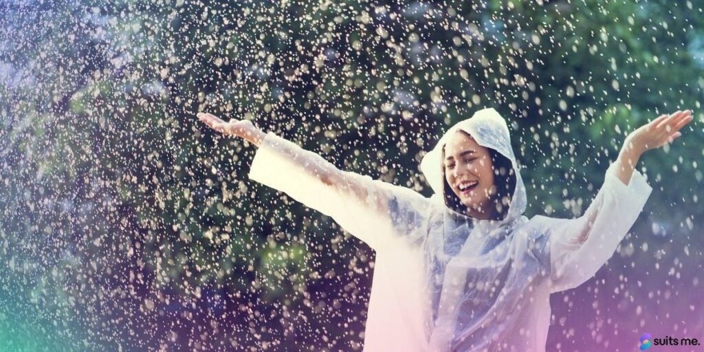 Woman in a White Coat, Dancing in the Rain Because She's Started a Rainy Day Fund to Achieve Financial Wellness