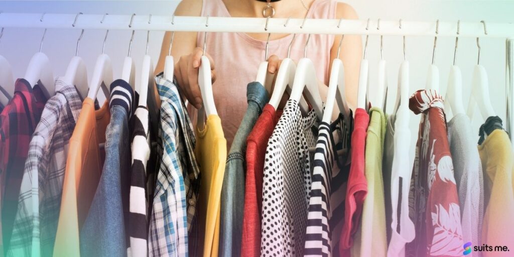 Woman Looking Through her Capsule Wardrobe with Clothes Hung on a Clothing Rail