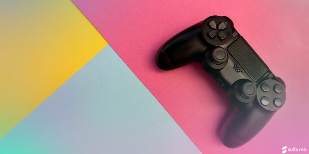 Video game controller on a yellow, blue and pink background