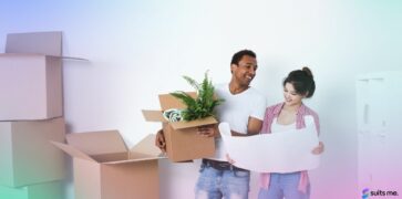 Couple moving into their new home in 2021 with their belongings in boxes - renting or buying a home concept