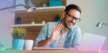 Happy Man working from home on a video meeting with colleagues. Hybrid working concept