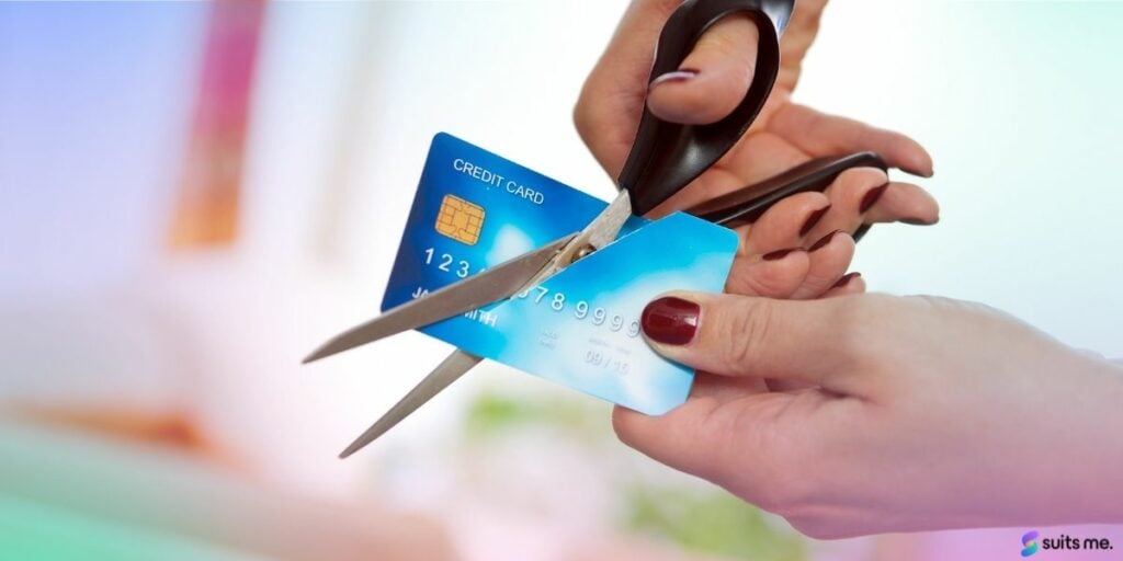 Person using scissors to cut up and cancel their credit card