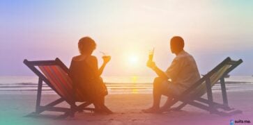 Couple being able to enjoy their holiday on the beach after saving money for it