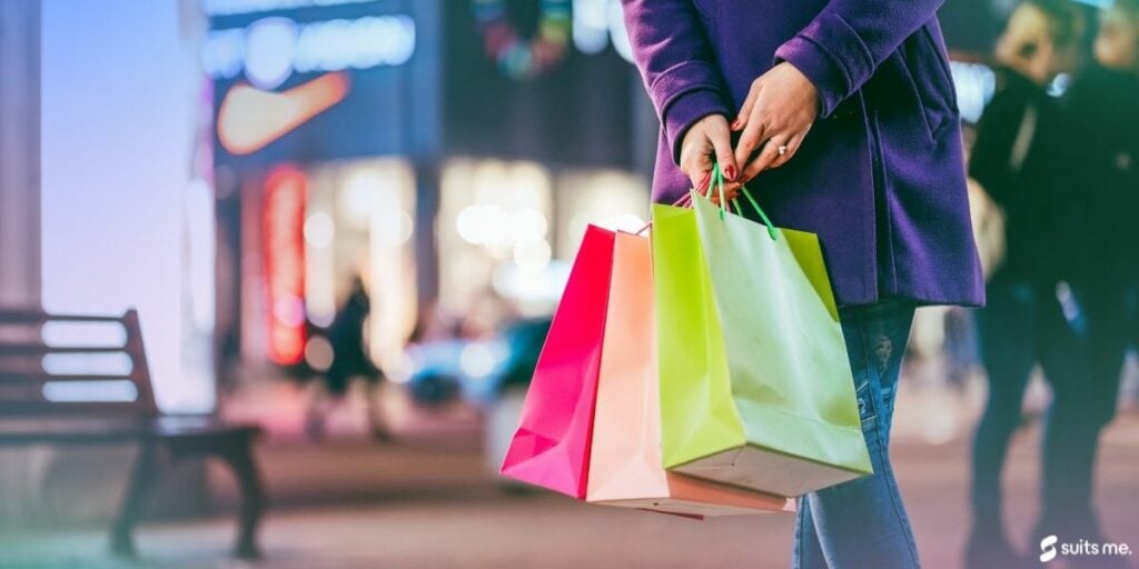 Woman on a shopping spree on the high street. Impulse spending concept 