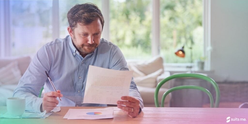 Man checking his bank statement and reviewing his overdraft fees