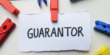 Post it note with pegs attached saying Guarantor