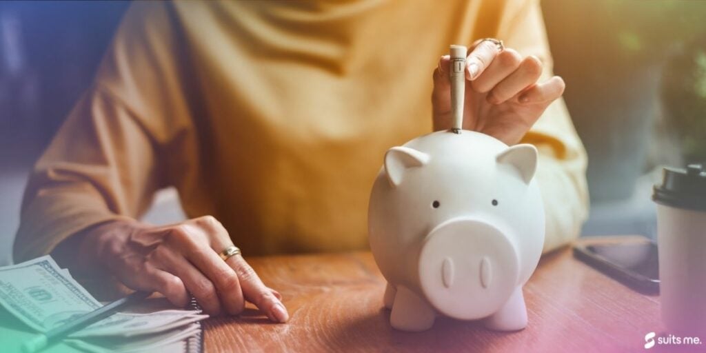 Person putting money into their savings pot