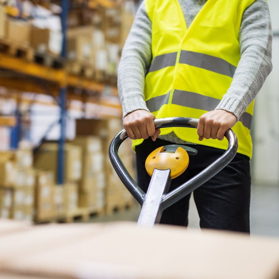 man working in a warehouse wearing a hi-vis jacket