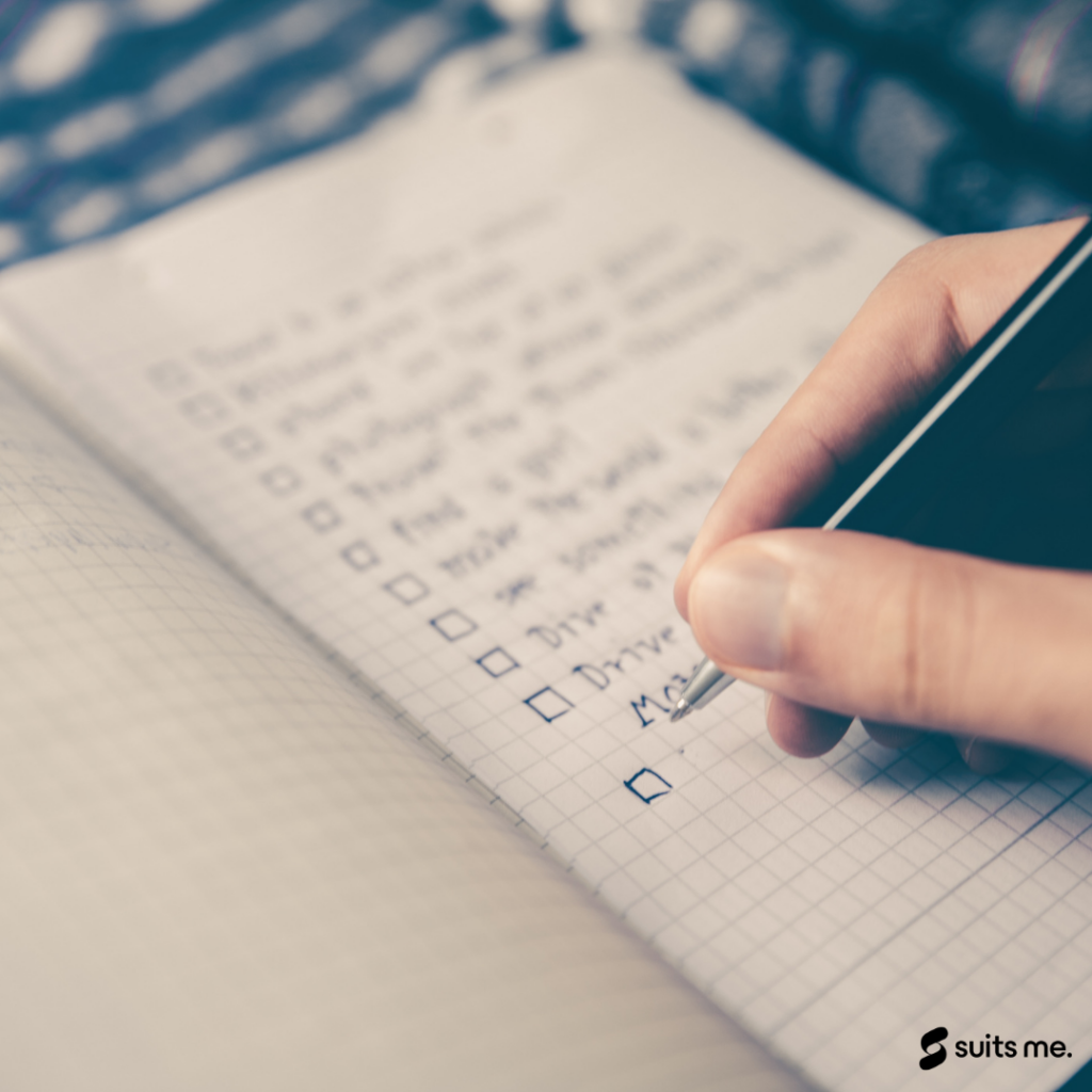 man writing his list of financial goals