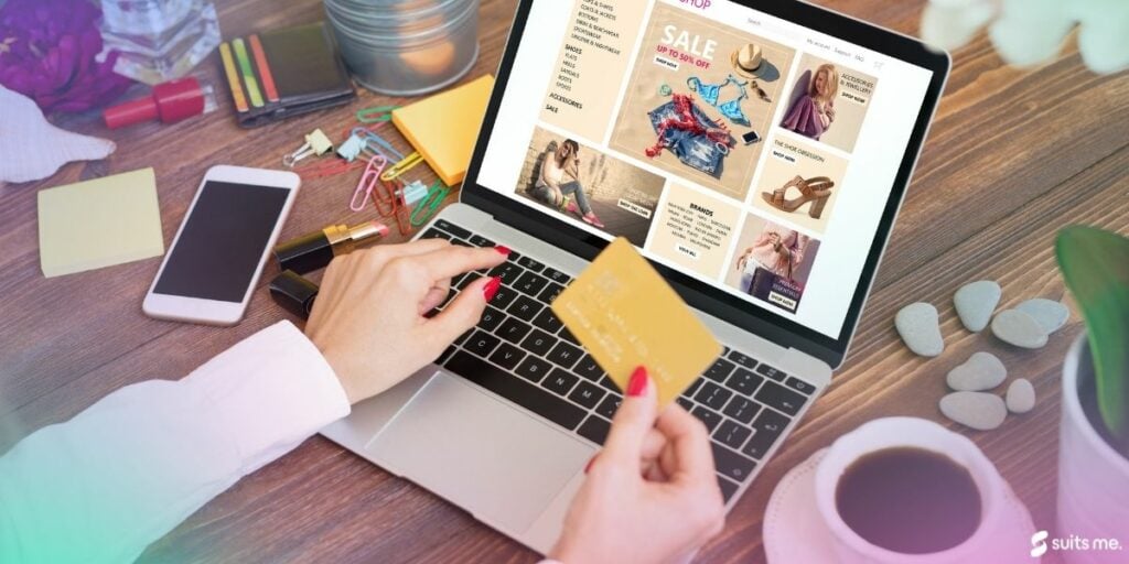 Woman typing on laptop with debit card in hard looking at sales online. 