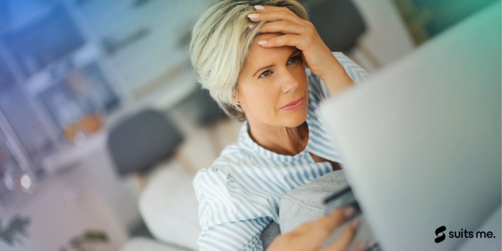 Woman looking at her laptop screen stressed that her debit card account has been blocked