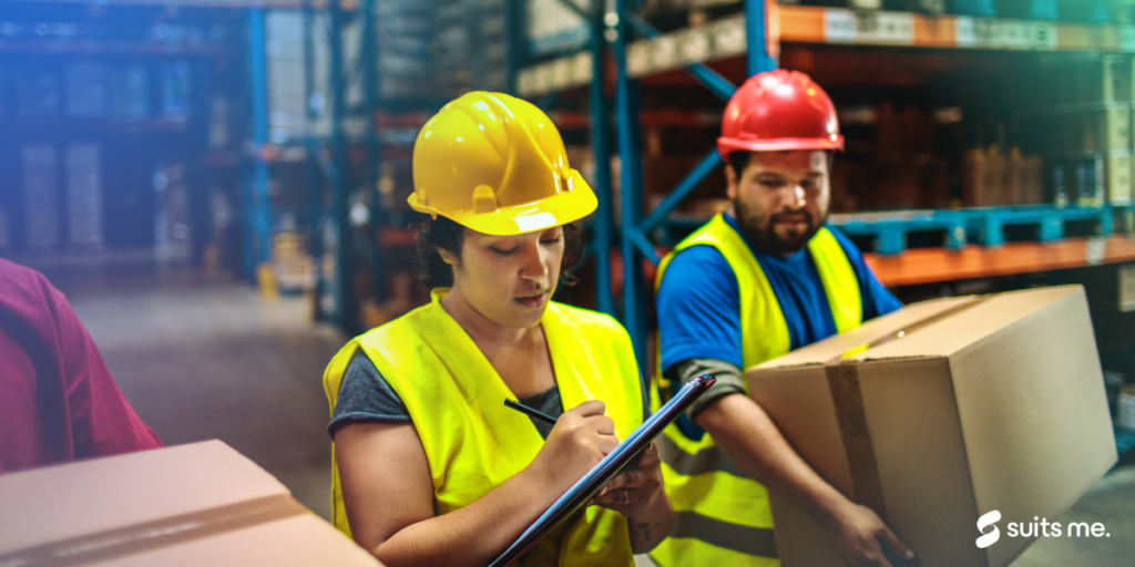 Woman writing on a clip board explaining to temporary workers what to do