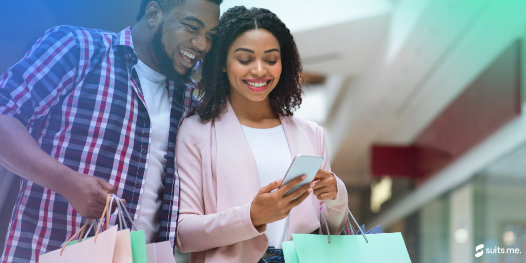 Man and woman looking at their phone, happy as they have recieved a cashback payment