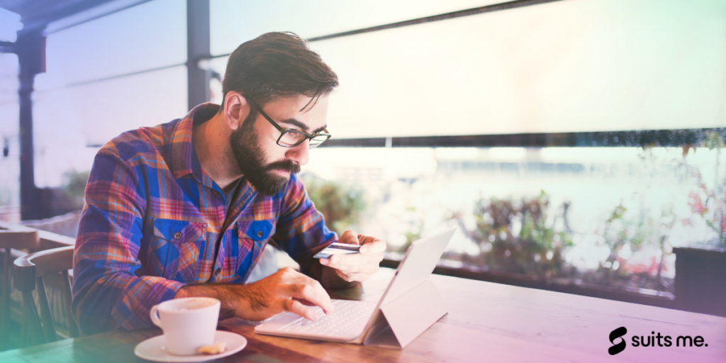 Businessman checking current account balance using online banking application on his smartphone, whilst drinking coffee at café